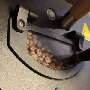 Coffee beans in a roaster that fall our of the chute in slow motion.